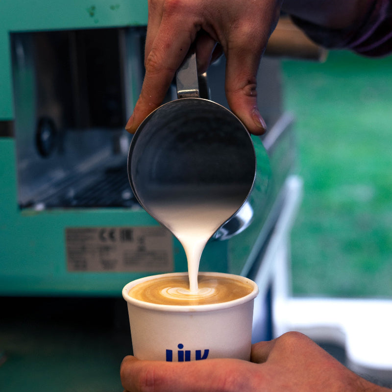 Latte milk being poured